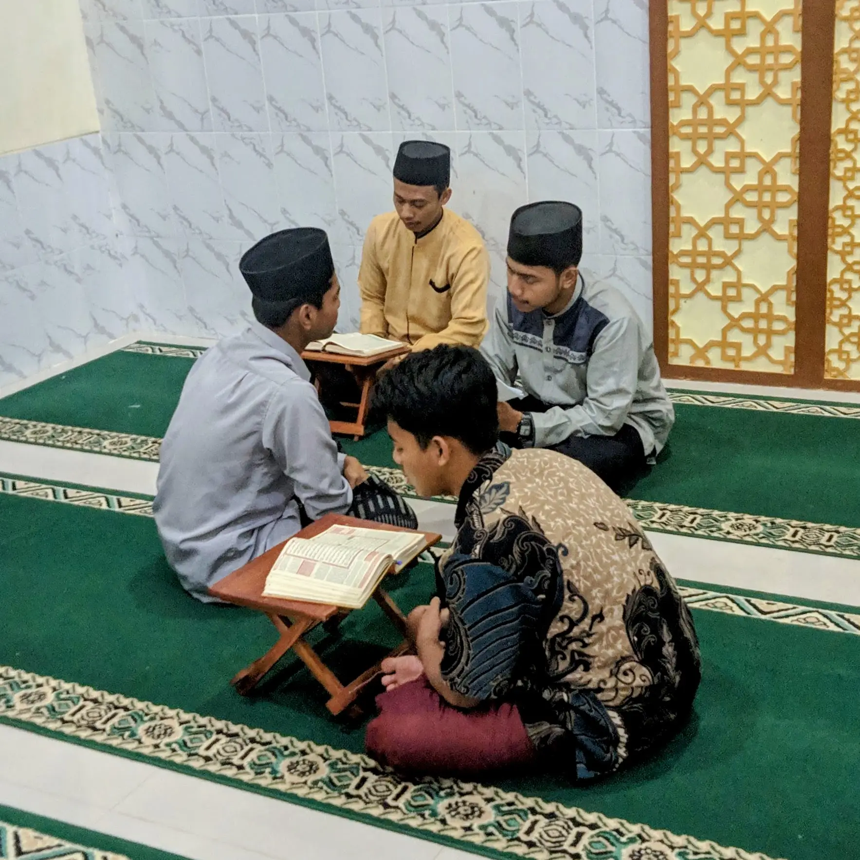 Santriwan sedang menyetorkan hafalan kepada muhafizh di pagi hari.